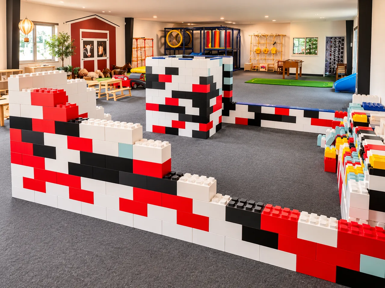 Large red, white, and black building blocks forming walls and towers in the main play space.